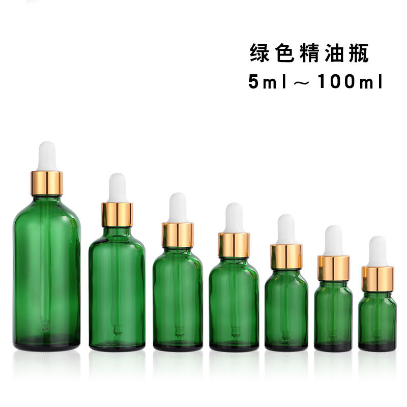 green essential oil glass bottle