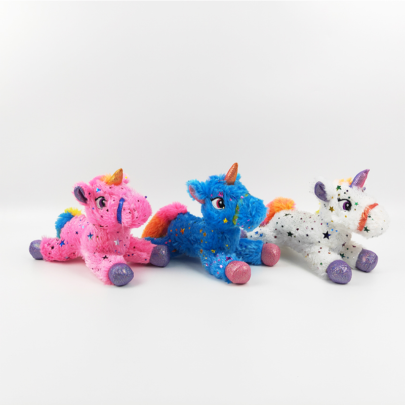 Plush lying unicorn with shinny stars