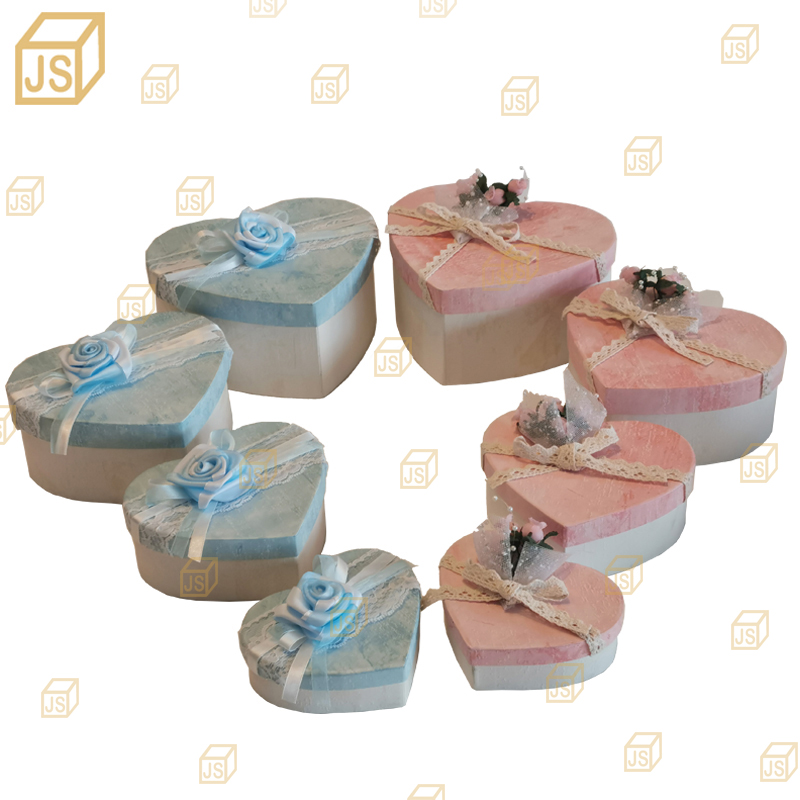New 2020 gift box. Heart-shaped gift box. Wedding packaging. Gift box with hand.