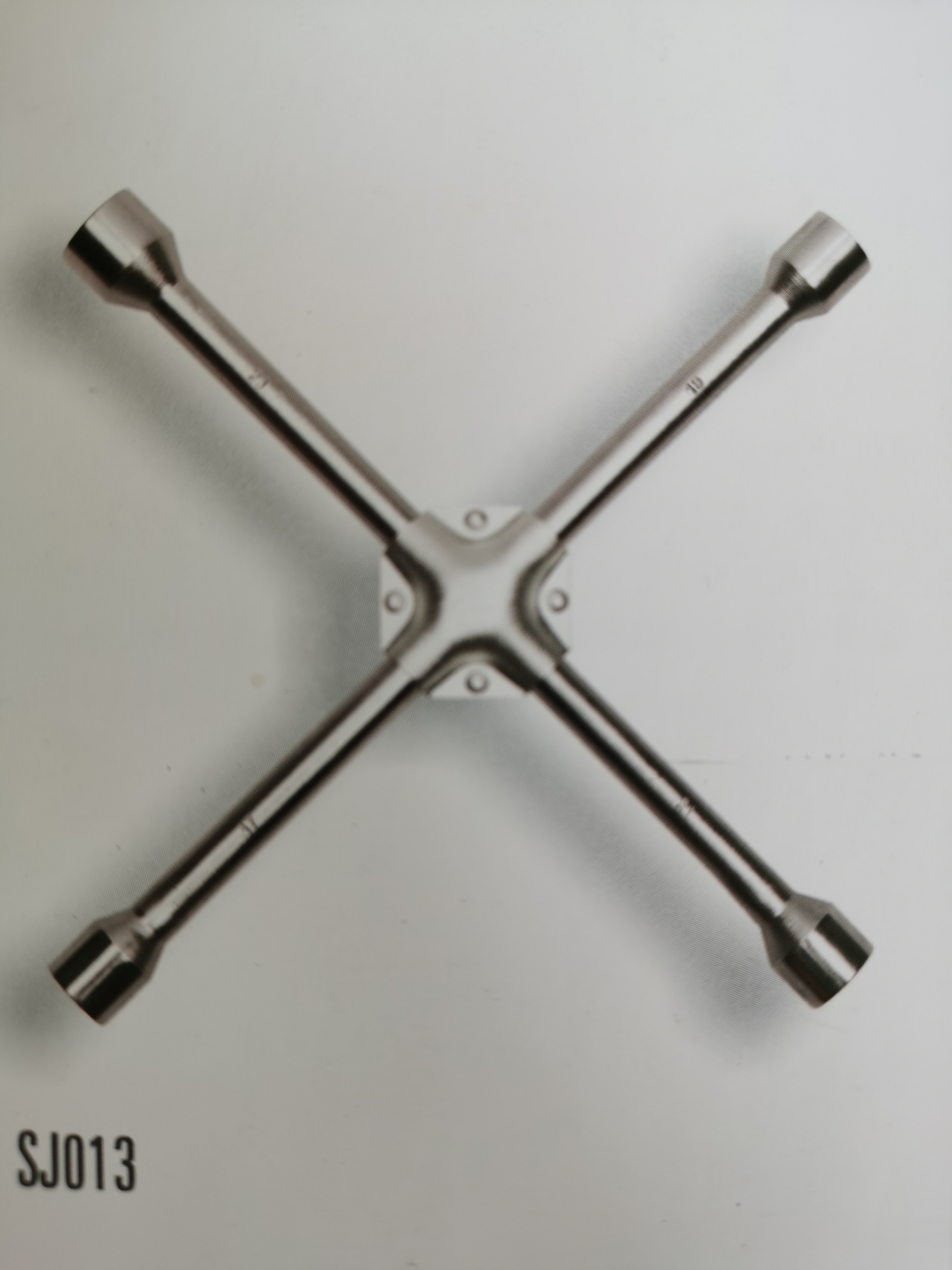 Cross rim wrench with iron pad