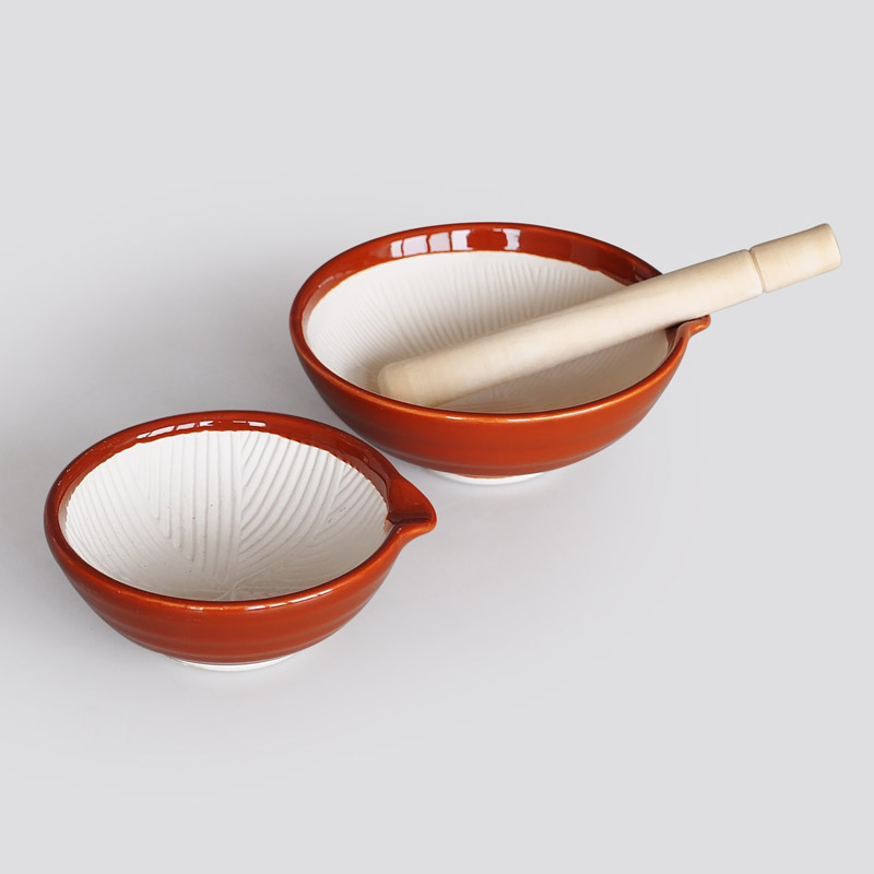 Ceramic grinding bowl with wooden grinding rod