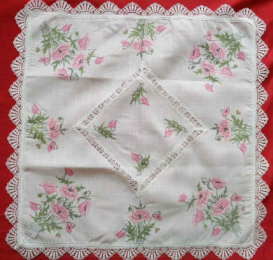 Cross-stitch poppy embroidery with lace table cloth