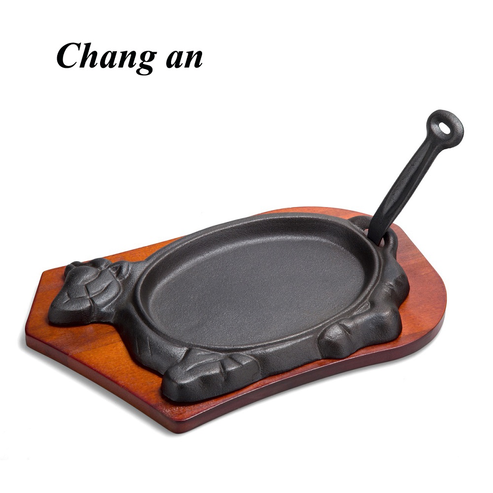 Cow shape cast iron steak platter with wooden tray