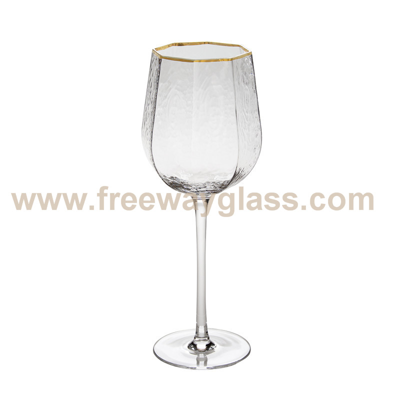 muti- facet wine glass with gold rim and harmer design