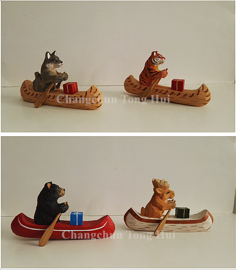 Wood carved animal sailing canoe