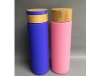 Glass water bottle with bamboo lid and silicone sleeve