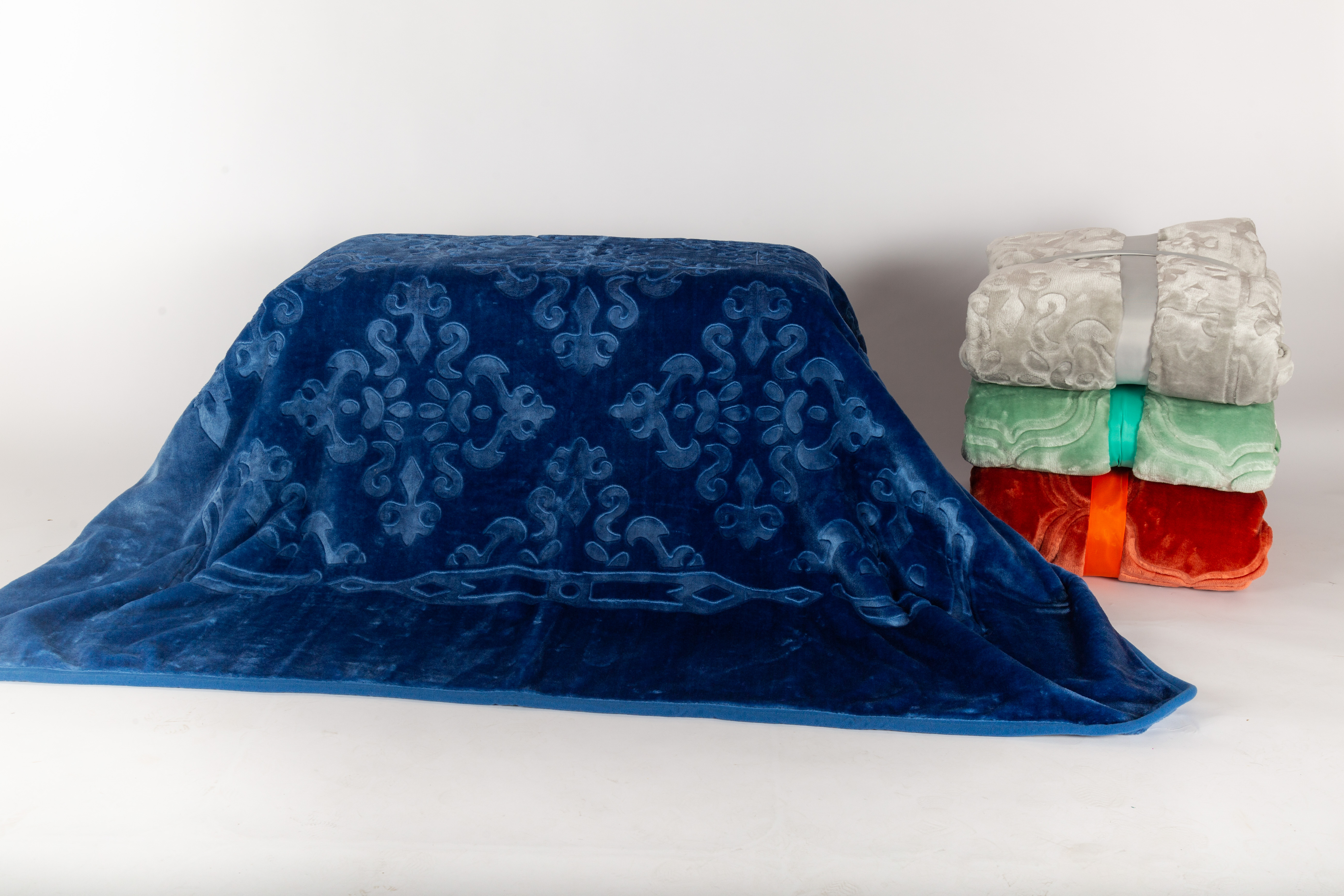 Solid embossed raschel blanket