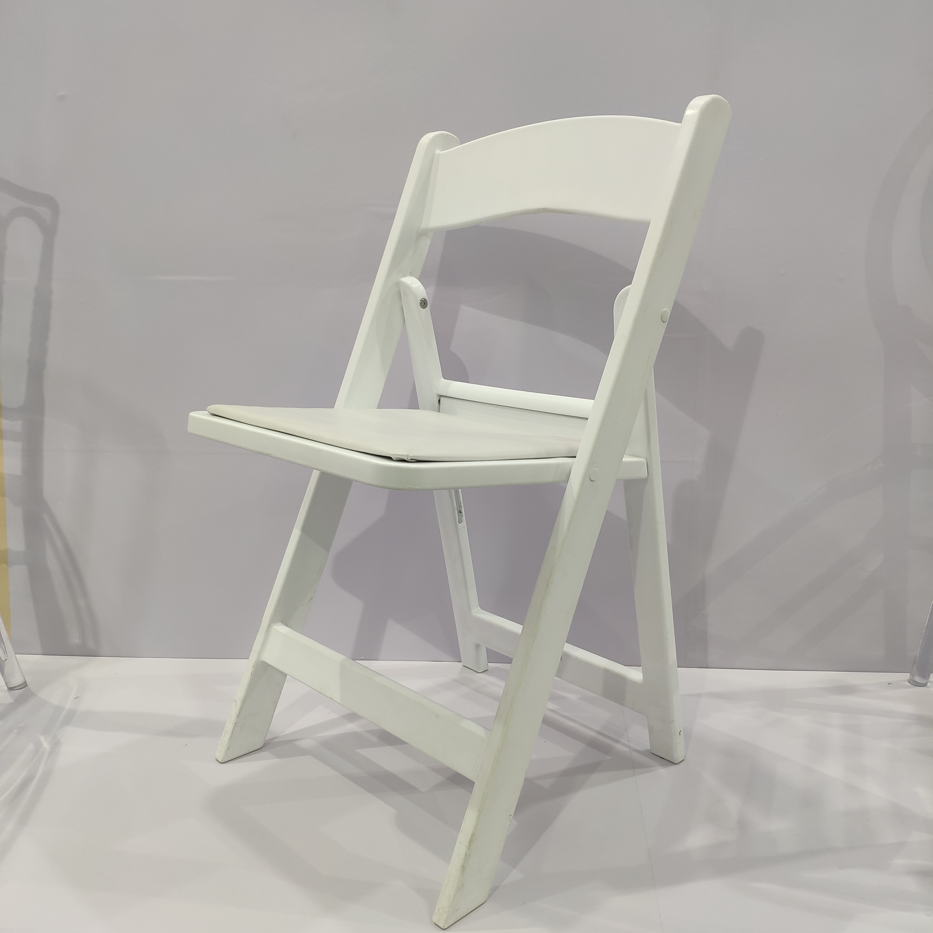 Plastic resin wimbleton folding chair with cushion
