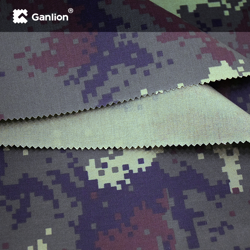 Water repellent, oil repellent camouflage fabric