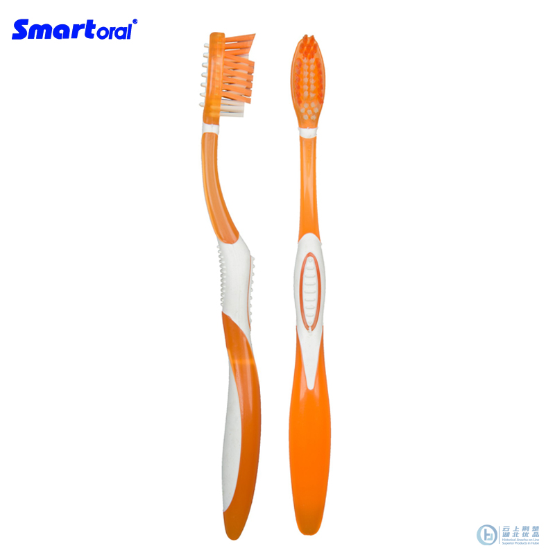 Adult toothbrush with cross action and tongue cleaner
