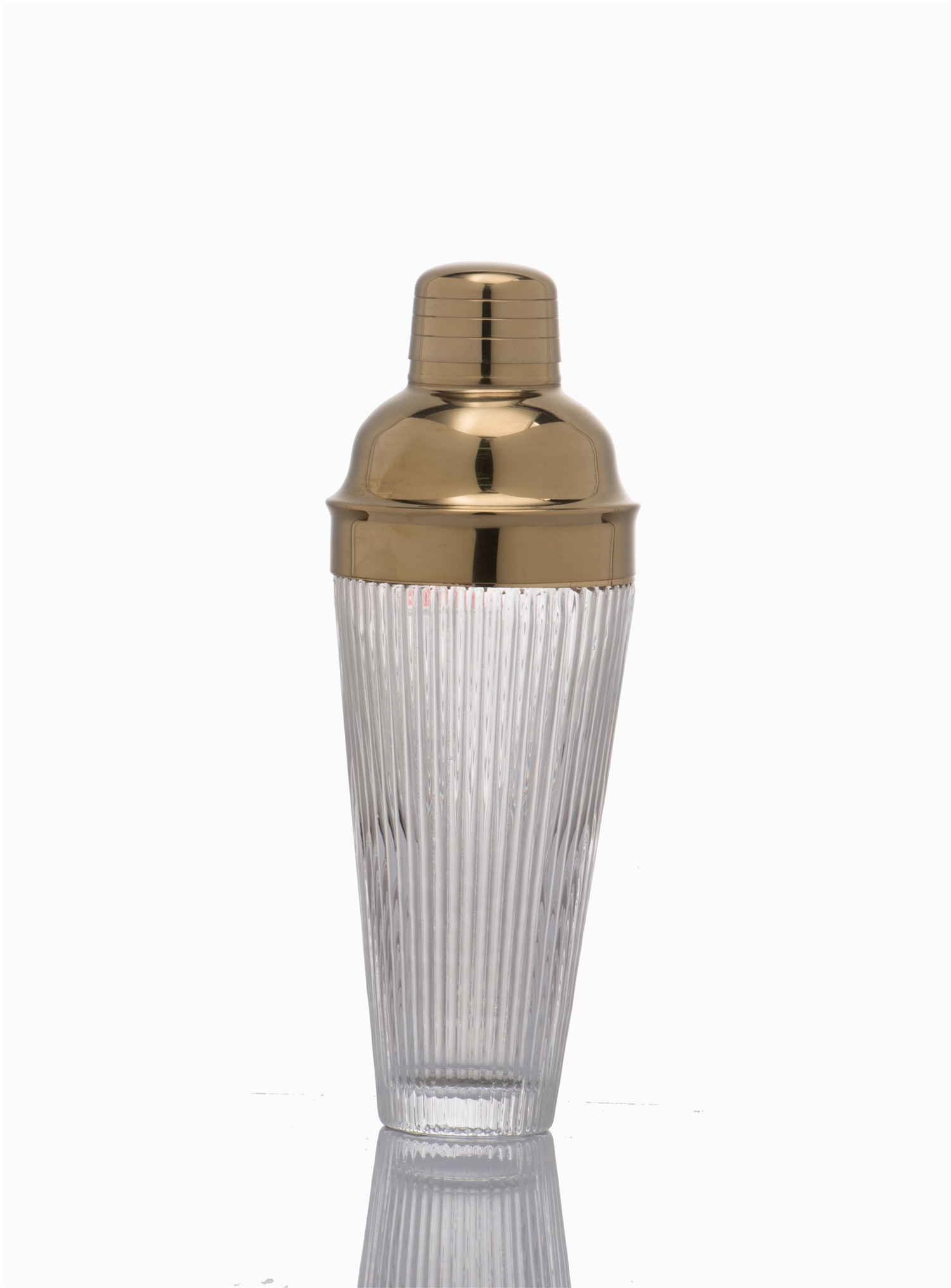 Clear ribbed glass shaker with gold lid
