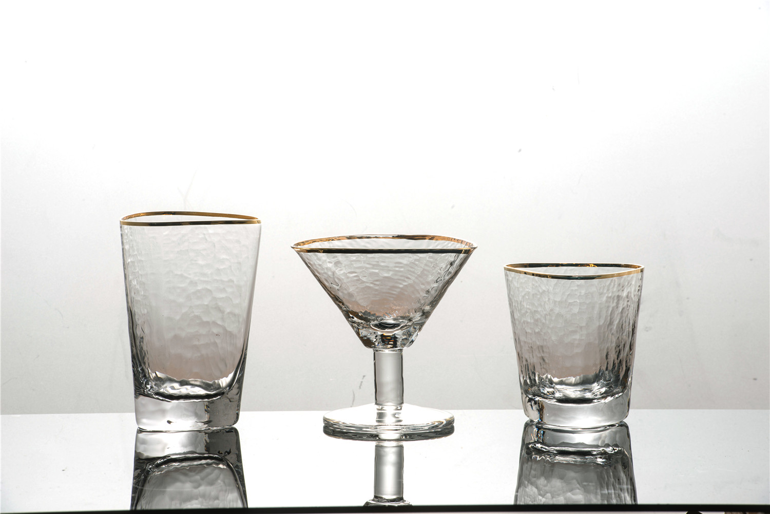 Clear hammered wine glasses with gold rim