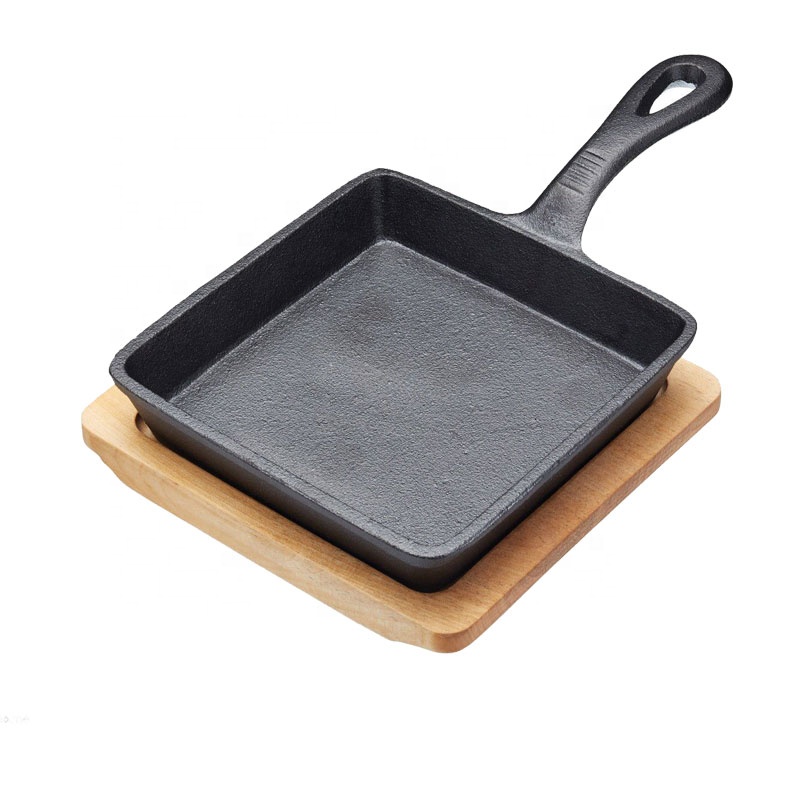 cast iron frypan with wooden base
