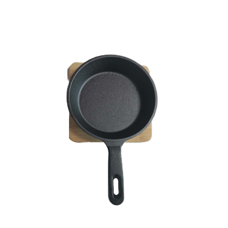 cast iron frypan with wooden base