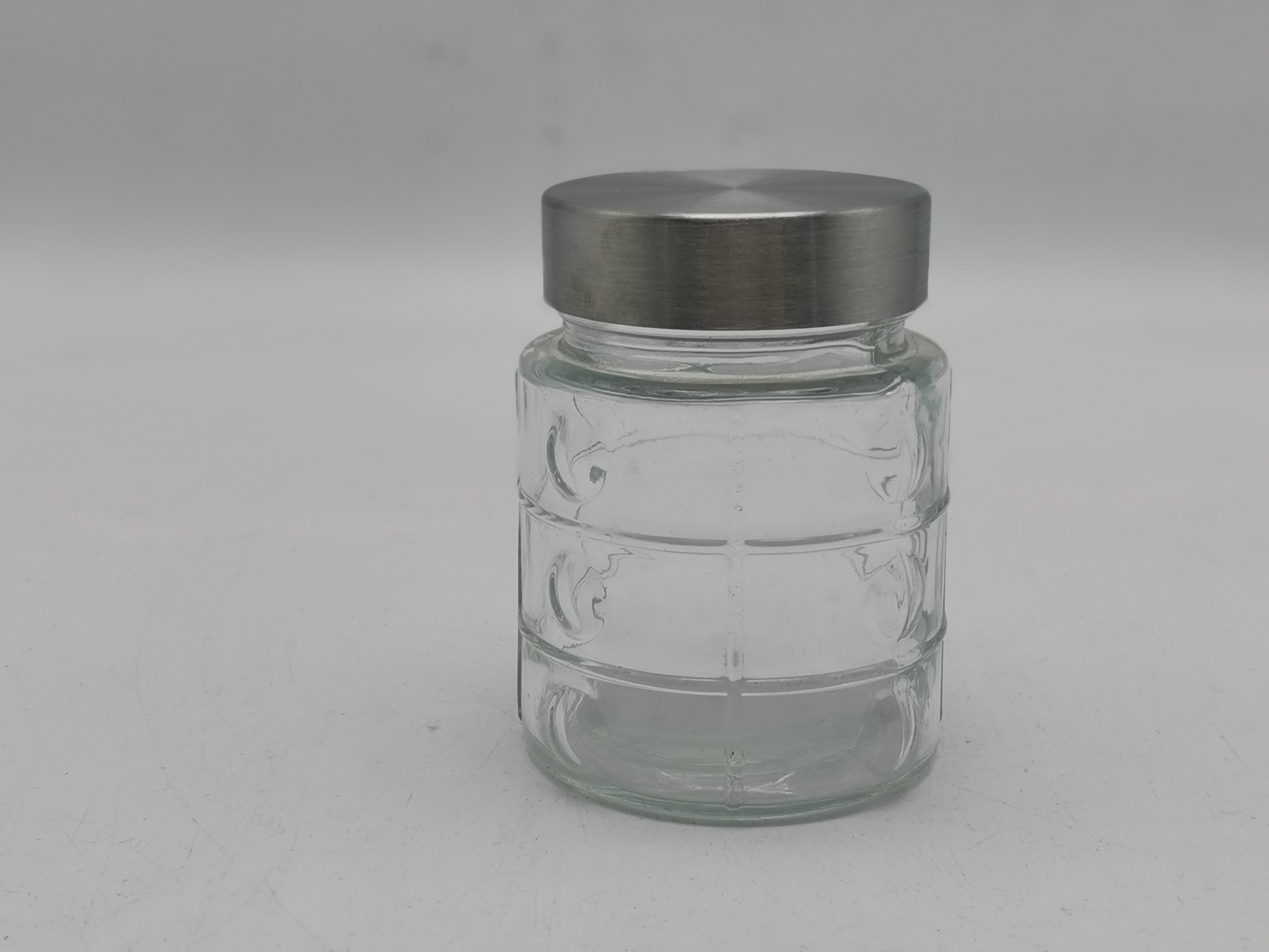 round glass jar with metal screw type lid