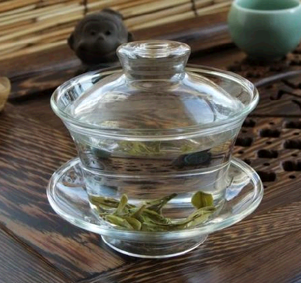 Glass cup with glass lid and saucer
