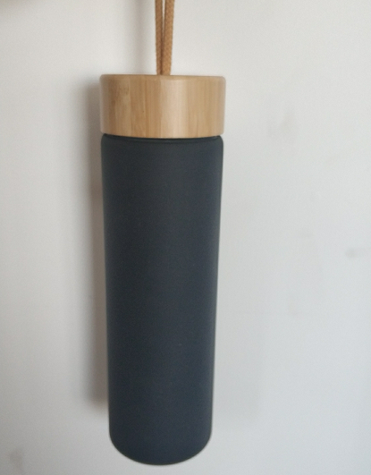 Glass water bottle with bamboo lid and silicone sleeve