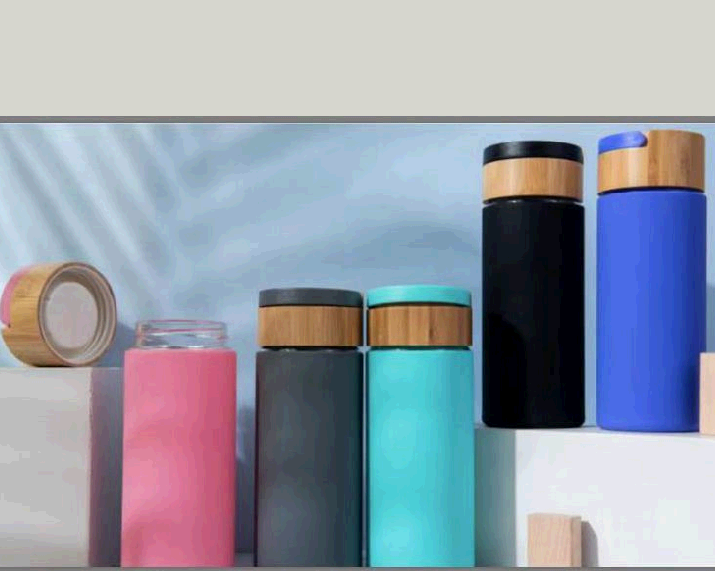 Glass water bottle with bamboo lid and silicone sleeve
