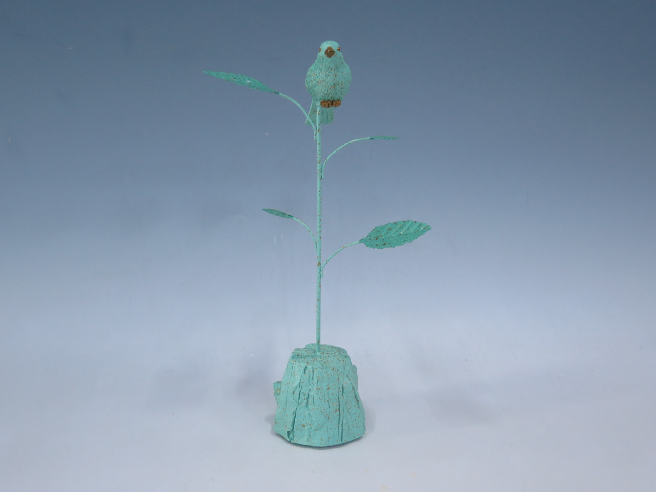 Bird standing on a branch in metal accesorry