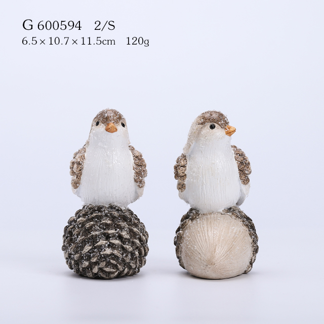 2/A resin bird standing on pinecone