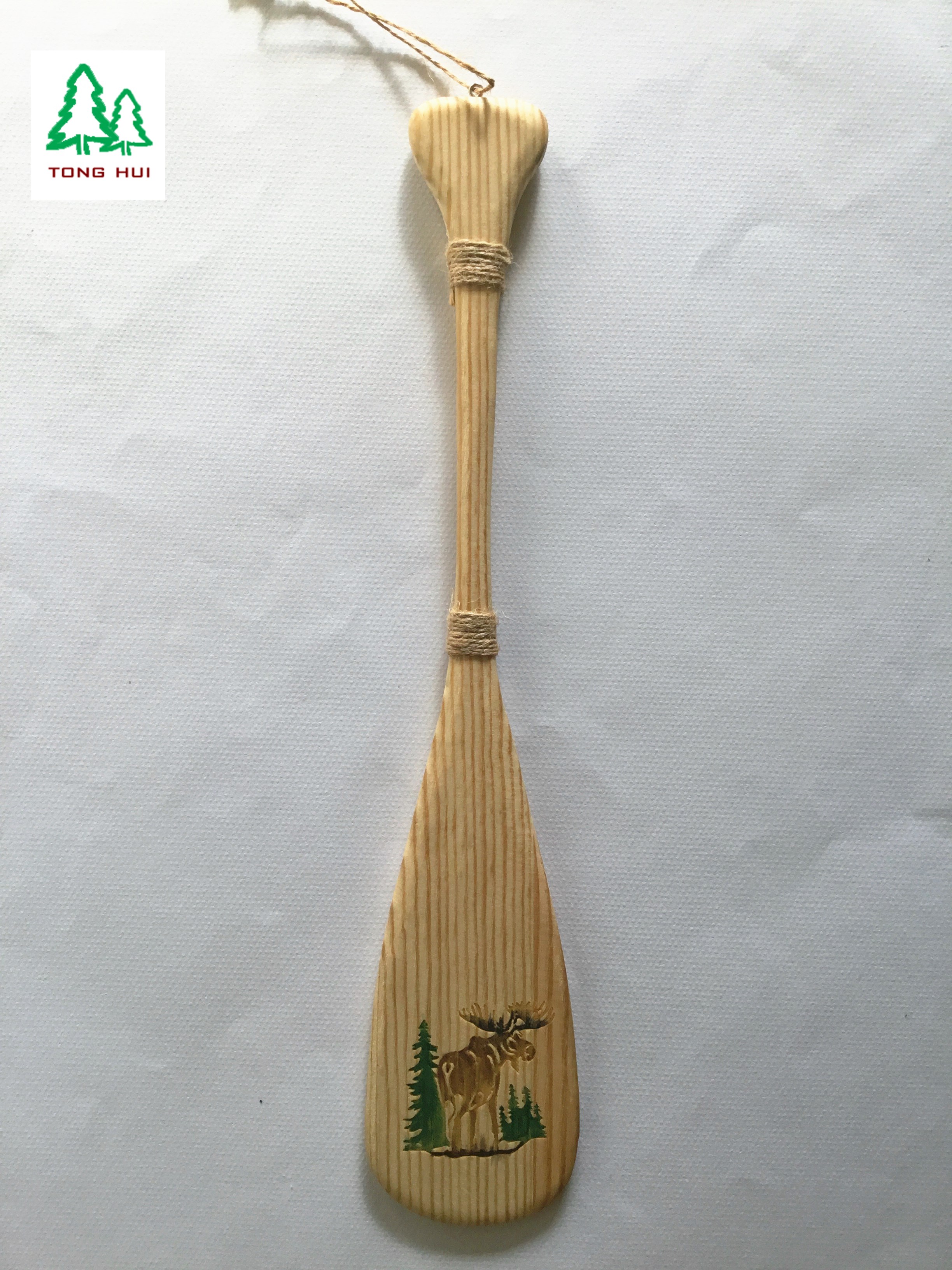 wooden paddle with carved animal design