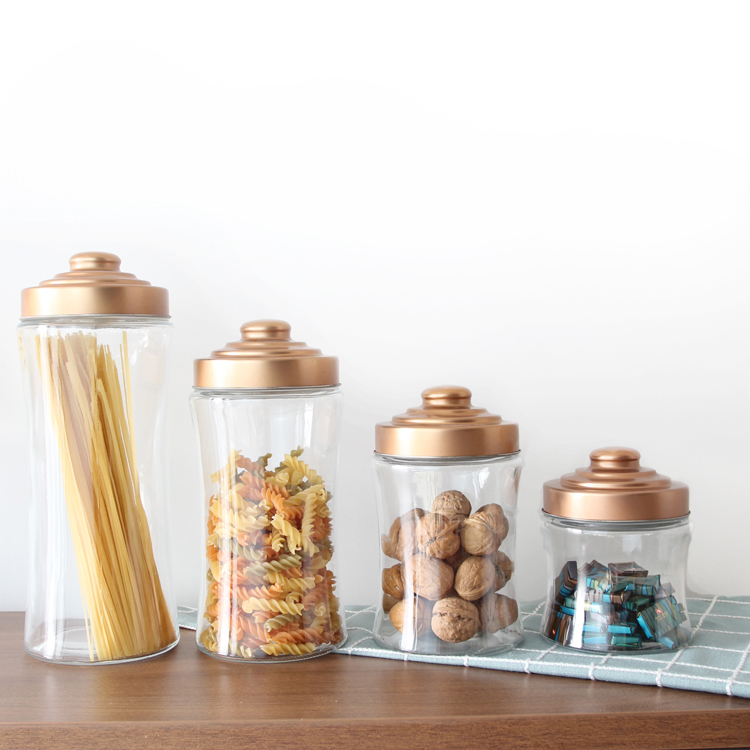 Glass storage jar with goden metal lid