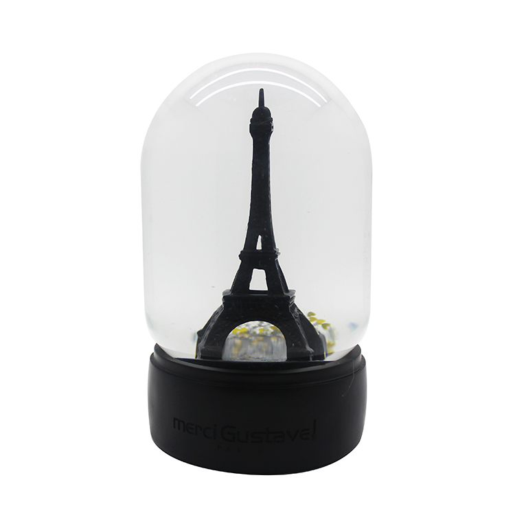 Golden Eiffel tower snow globe