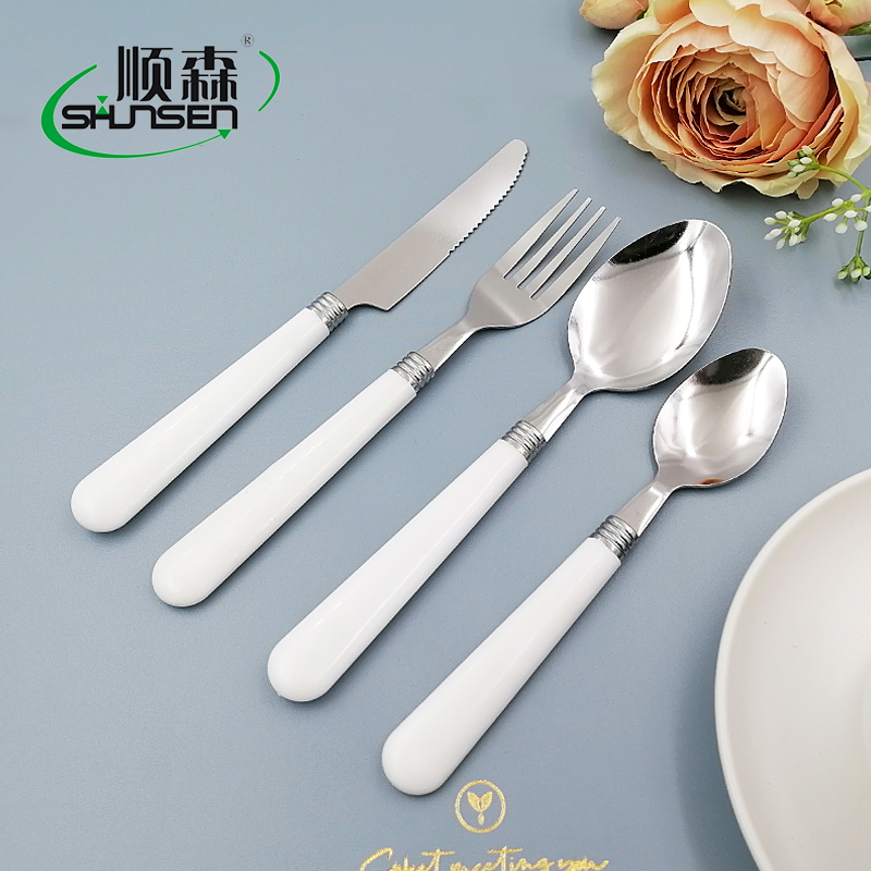 White plastic handle stainless steel tableware
