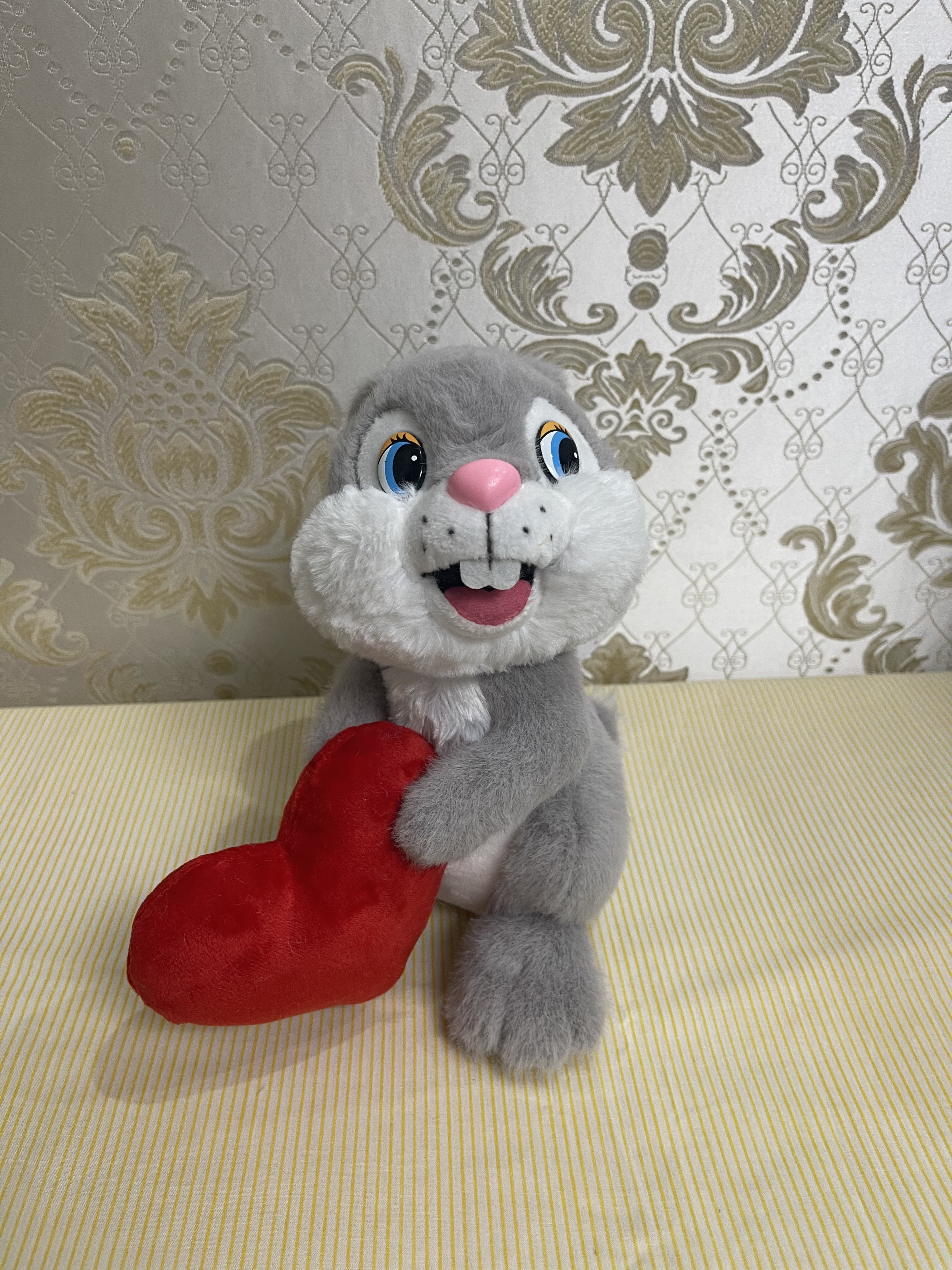 Gray rabbit holding chicken heart plush toy
