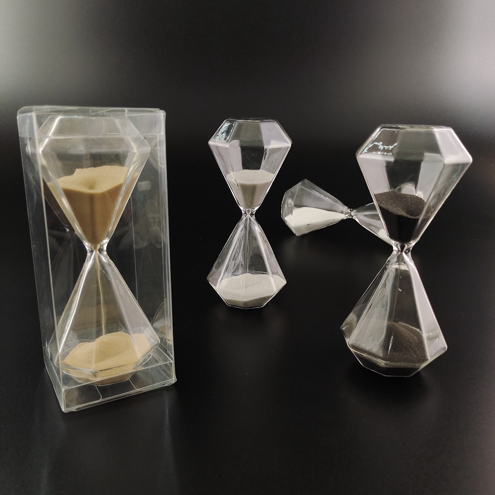 Glass hourglass black sand